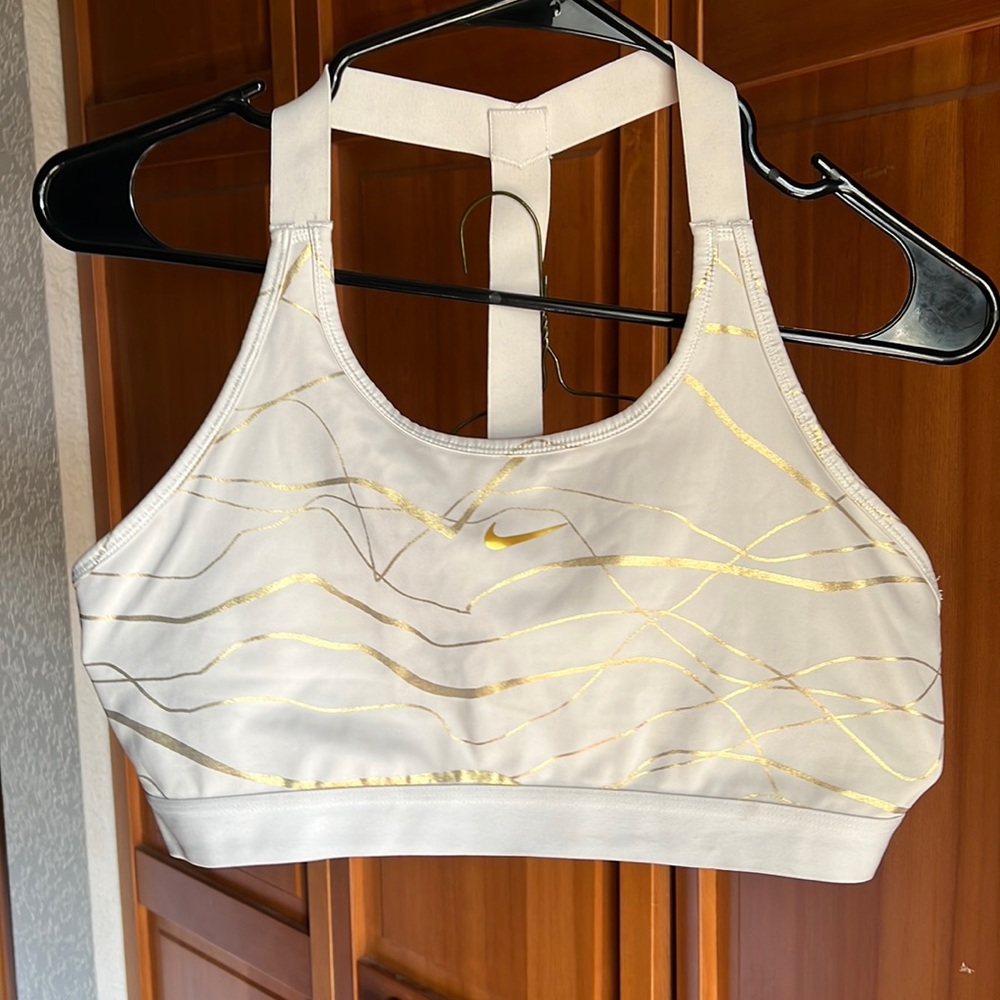 Gold and white striped Nike sports bra